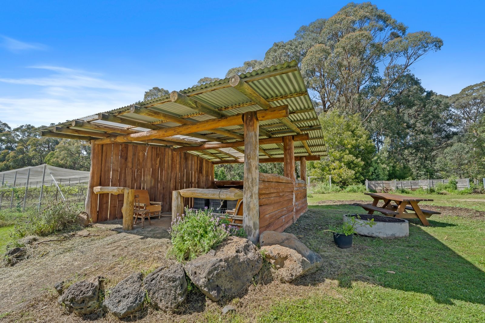 A stone fire pit and shelter in the grounds
