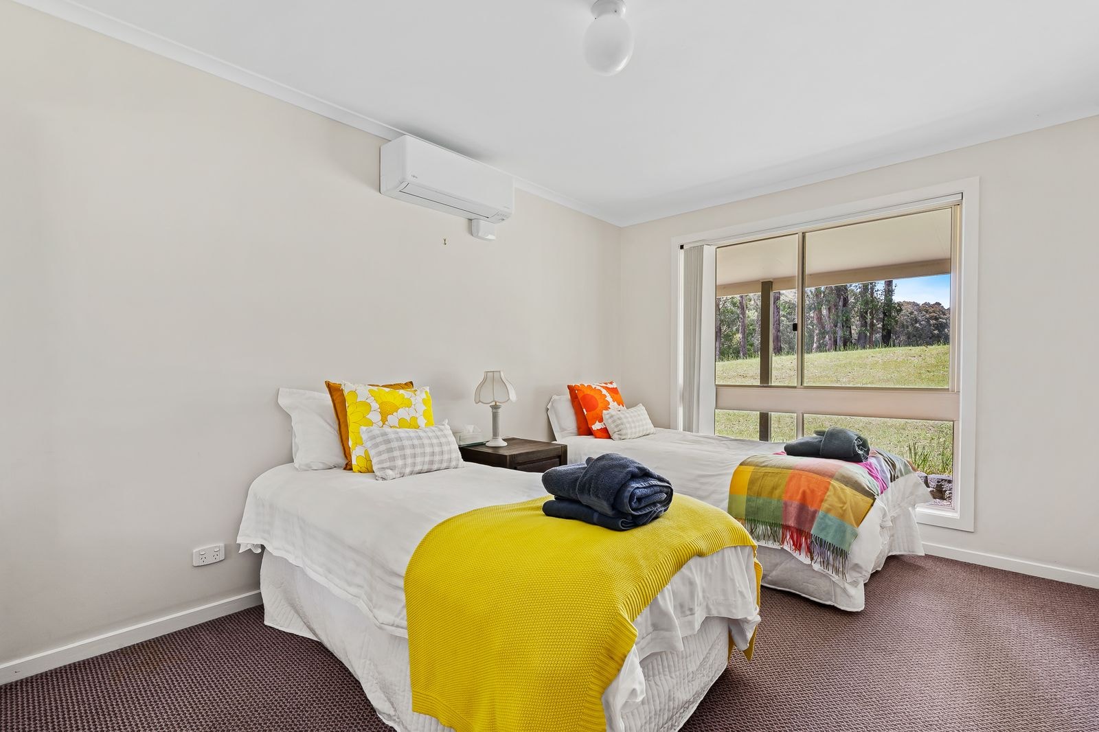 A twin guest room with bright bedding